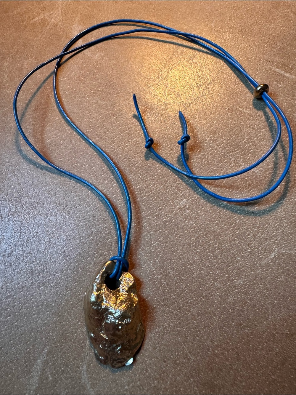 Gold brass pendant necklace textured shell beach mermaid on blue leather cord